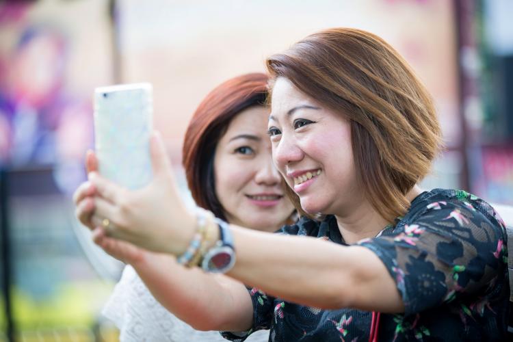 Two friends taking a selfie together.