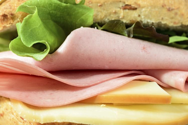 Sandwich with cheese, lettuce and bologna.