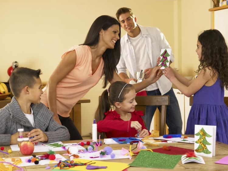 Family making holiday cards.