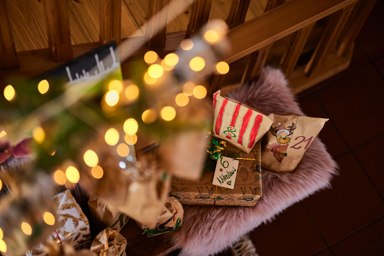 Little Santa stands next to an Armenian wooden Christmas tree toy