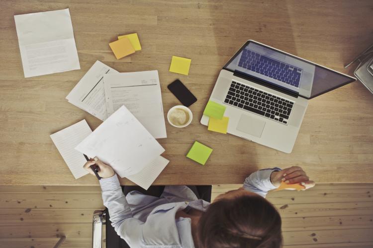 Overhead view of businesswoman working at desk.