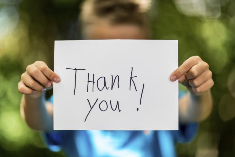 Boy with thank you sign.