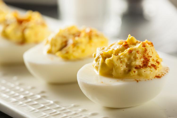 Healthy deviled eggs on a white platter.