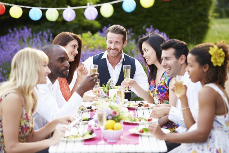 A group of friends enjoying an outdoor dinner party.