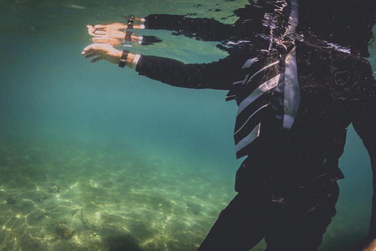 Man in suit under water.