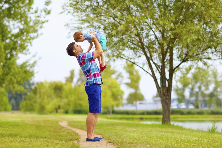 Father and son having fun in a park.