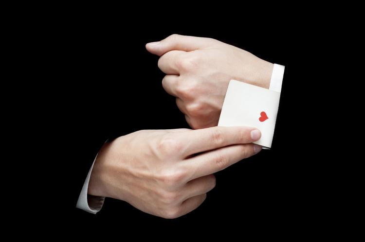 Ace card hidden under sleeve.