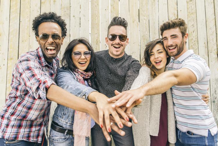 Group of people smiling and cheering.