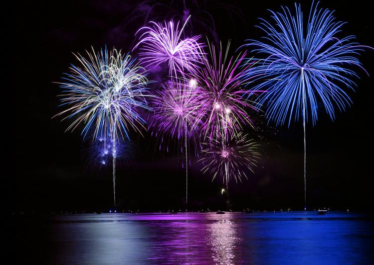 Fireworks blended over large clock face