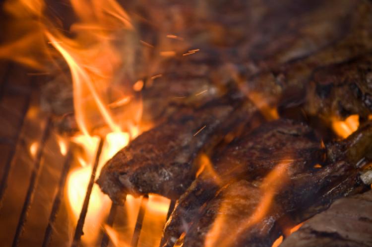 Close detail of lamb chops flame grilling