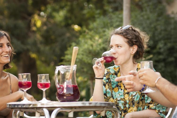 Young woman drinking sangria with friends.