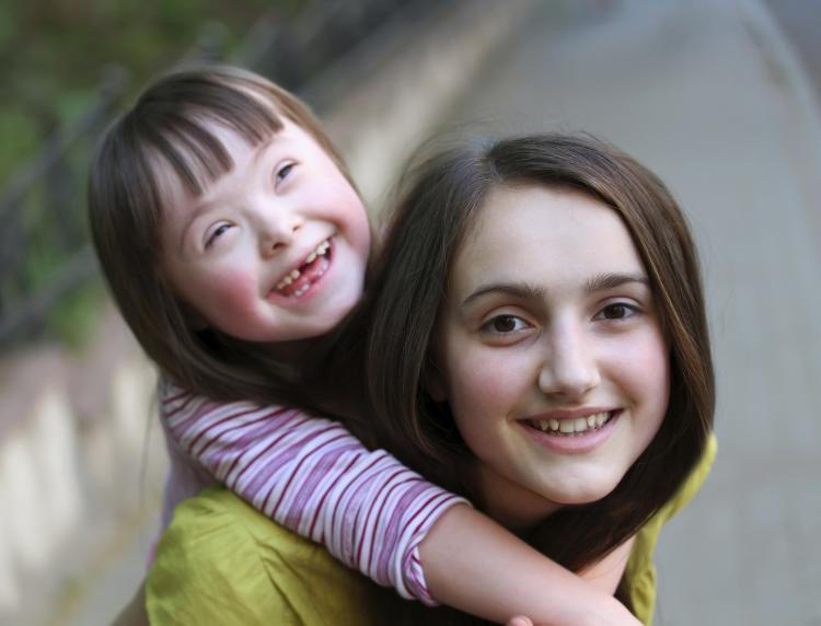 Girl with a younger girl on her back.