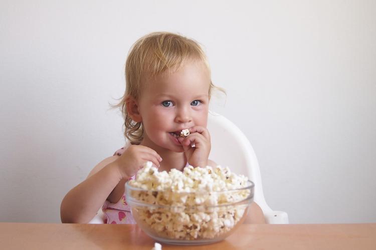 Children and adults alike enjoy popcorn.