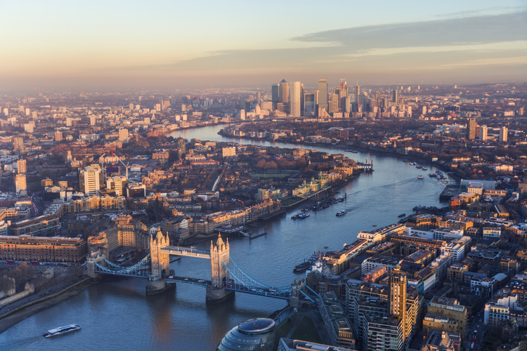 London city skyline at sunrise with the London Bridge and the Thames.